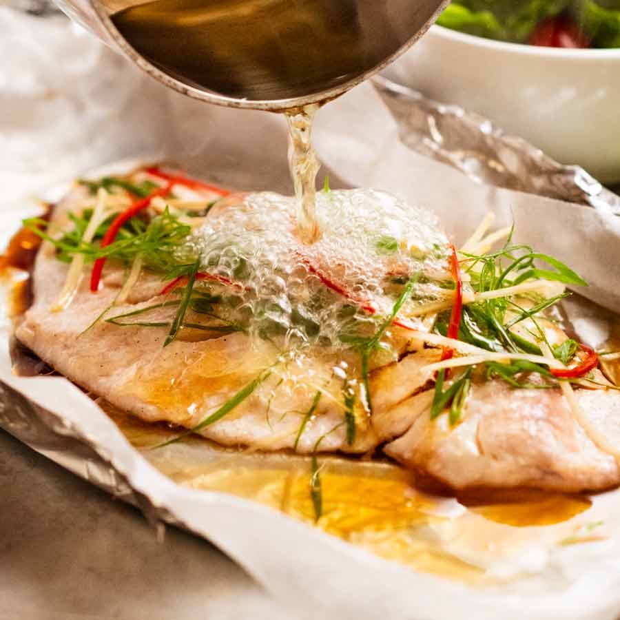 Pouring hot oil over Sizzling ginger fish